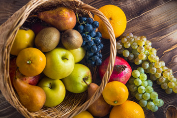 Composition with assorted fruits in wicker basket, healthy life