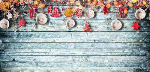 Christmas background with hand made cloth decorations on wooden planks.