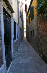 Fototapeta na wymiar narrow Venetian street called Calle in Italy