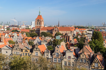 Old residential buildings at the Main Town (Old Town) and St. Cathrine's Church in Gdansk, Poland, viewed from above on a sunny day.