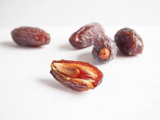 Half dates fruit on white background.
