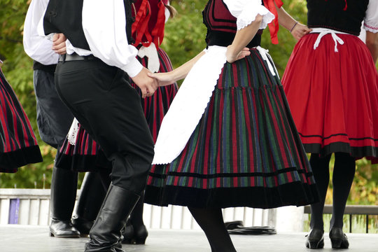 Hungarian folk dancers dancing in black, white and red.
