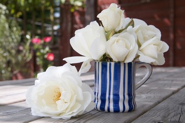 white roses on wood table garden