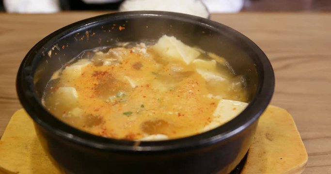 Korea spicy kimchi tofu soup bowl in restaurant