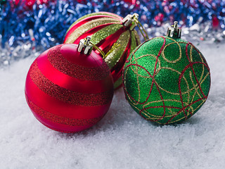 Christmas balls in snow on a blurred background