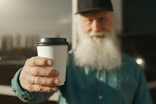 Old Man With Beard And Coffee In Hand