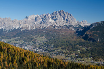 View of the rocky mountain ridge and a small mountain town in the valley