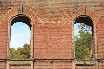 Two through window embrasures in the old brick wall of an ancient house