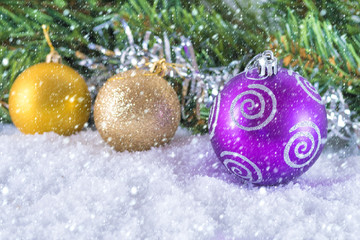 Christmas balls on a background of Christmas tree branches. Cold shade