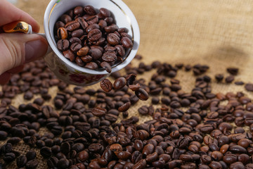 Spilling out coffee beans from cup