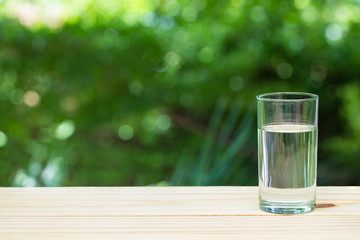 a glass of water on nature background.