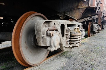 rusty wheels and spring cars close to the train