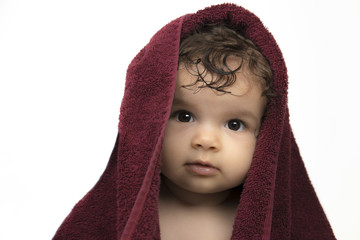Mixed race baby in red towel, isolated on white background