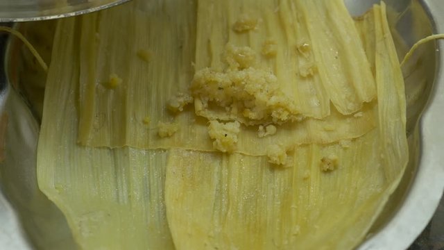 Full Shot Of Filling Tamales Chala Leaves On A Tray