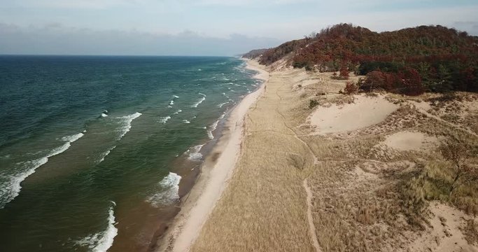 flying down the beach over the dunes along the lake