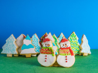 Christmas snowmans and trees ont eh background cookies winter composition.