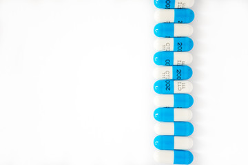 Right side vertical line of alternating white and blue capsules pills