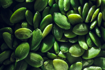 Macro background texture of green pumpkin seeds