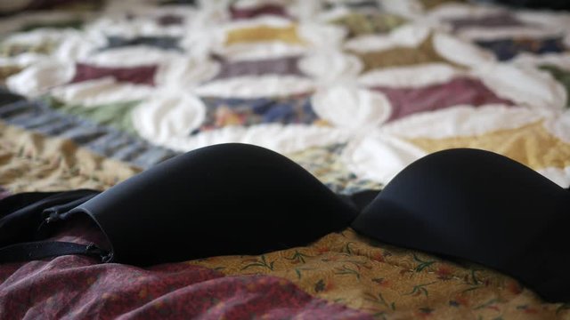 Black Bra lands on bedspread - Scandal concept
