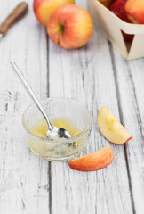 Old wooden table with fresh made Applesauce