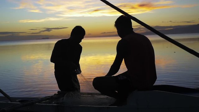Philippines, people on boat at sunset