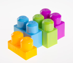 Plastic building blocks or colour blocks on a background.