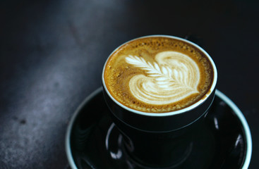 Hot latte coffee with black cup