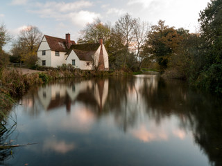 Fototapeta na wymiar beautiful willy lotts cottage autumn long exposure blurred water constable country flatford mill