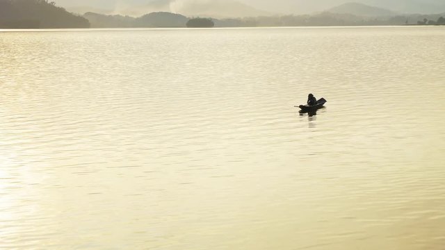 Person on boat in Nui Coc Lake, Vietnam