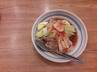 Japanese noodles in a cup on a table.