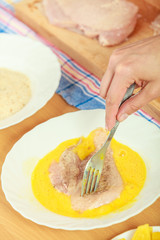Preparing meal of breaded chicken cutlets