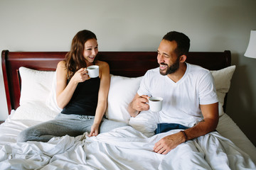 couple drinking coffee in bed together