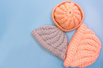 vintage design winter yarn hat on light blue background, top view