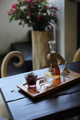 Berries tea with ice ball on wood background