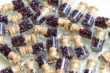 red garnet minerals in glass bottle