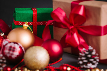 Composition with Christmas decorations  and gift on black background