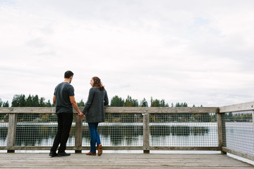 Couple standing on the dock at the lake