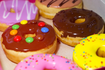 Six colored donuts in a box. Sweet donuts with glaze