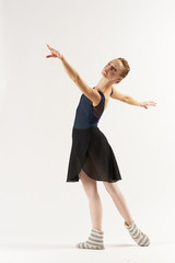 ballerina performs reception on a light background