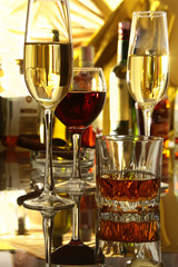 Glass of wine, brandy or cognac on the mirror wooden table