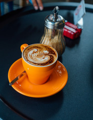 coffee in orang cup on black table top