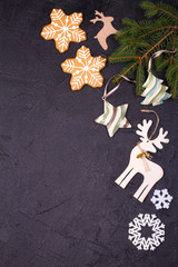 Christmas and New Year border or frame on black background. Winter holidays concept. View from above, top studio shot, vertical
