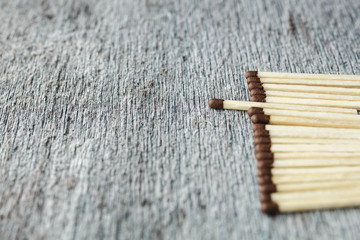 a row of matches against a gray background