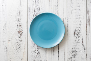 Blue Plate on white wooden background