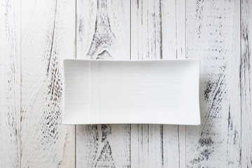 White rectangular Plate on white wooden background