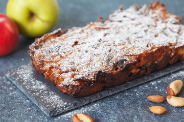 Fruitcake with apple and nuts on the slate