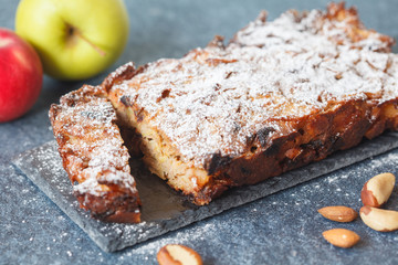 Fruitcake with apple and nuts on the slate