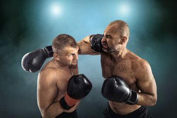 Fototapeta na wymiar Two professional boxers, athletes in dynamic boxing action on th