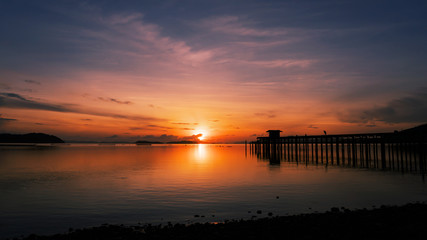 scenery view of old jetty to the sea beautiful sunrise or sunset in phuket thailand.
