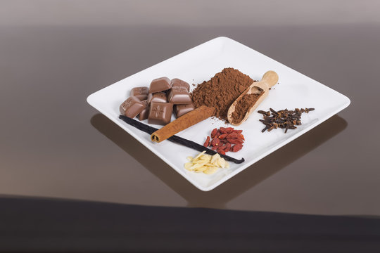 Plate of spiece and chocolate on the glass table